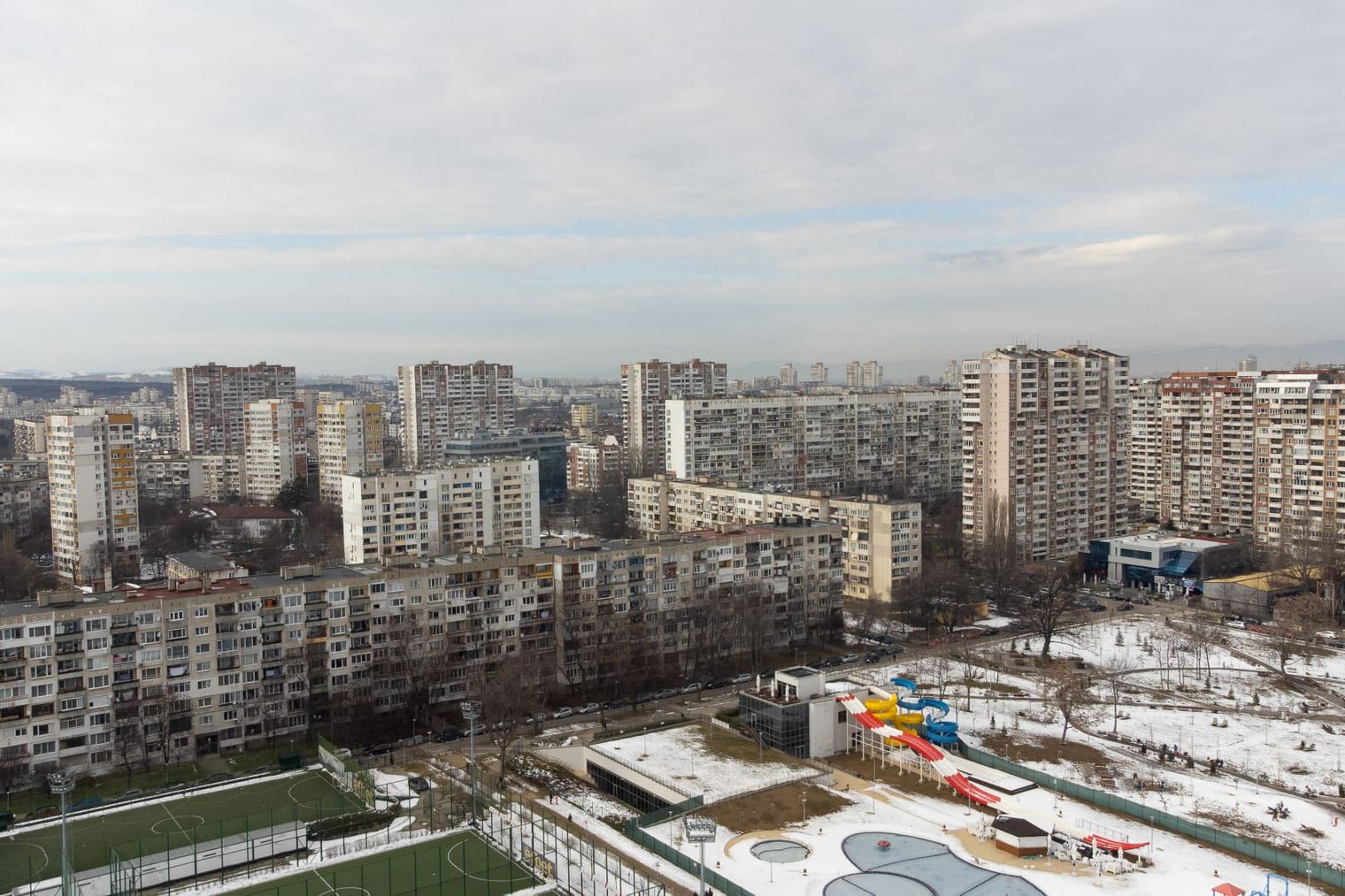 Panel apartment blocks of the Lyulin district against a snowy Sofia skyline